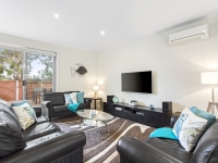 Spacious lounge with seating for 10+,  looking to front deck